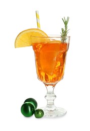 Photo of Tasty Christmas cocktail in glass and baubles isolated on white