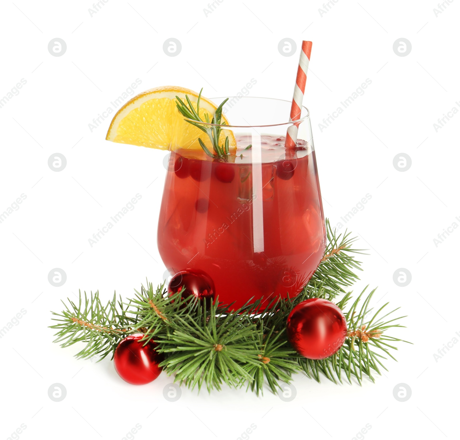 Photo of Tasty Christmas cocktail in glass, baubles and fir tree branches isolated on white