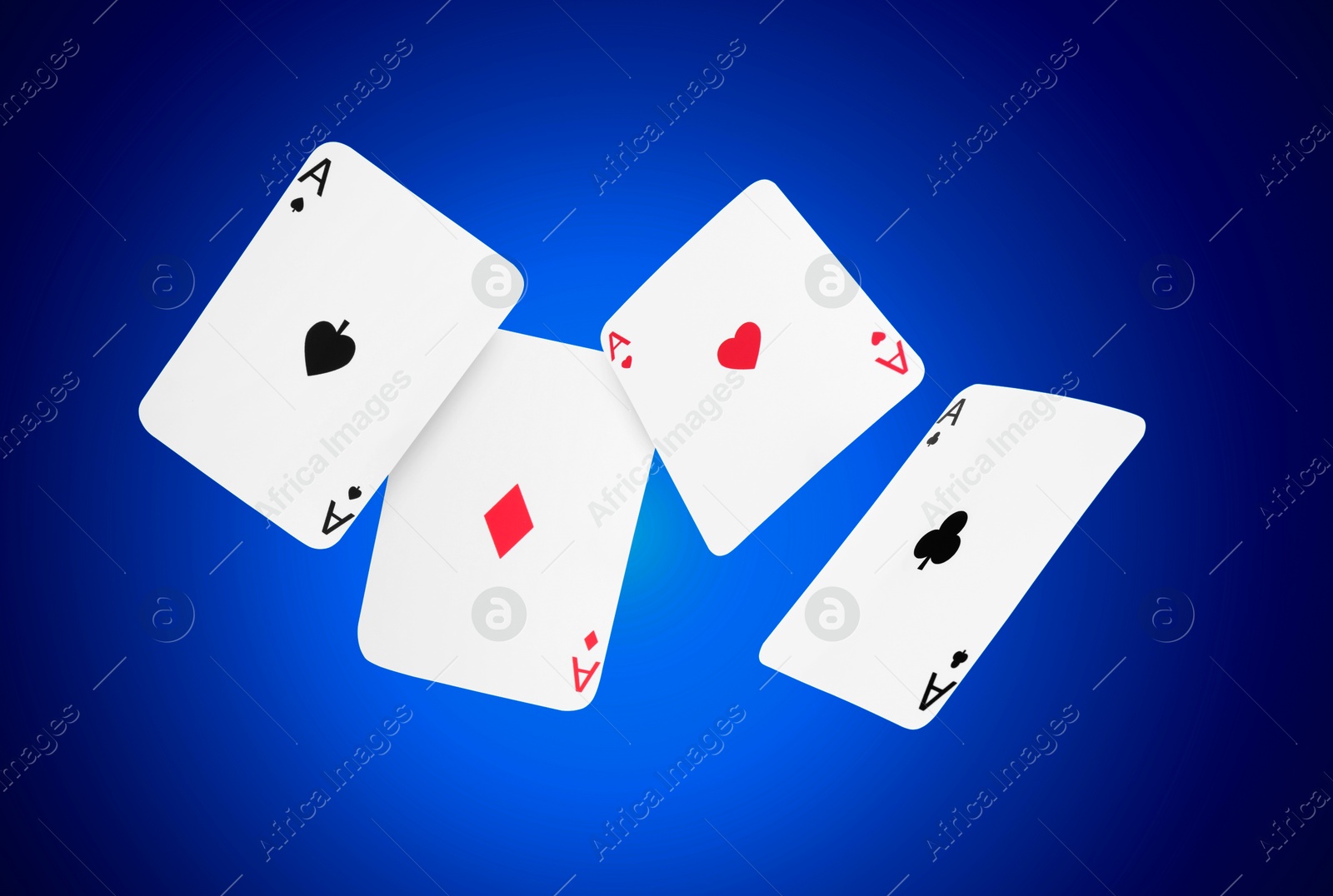 Image of Four aces in air on blue gradient background. Poker and other card games