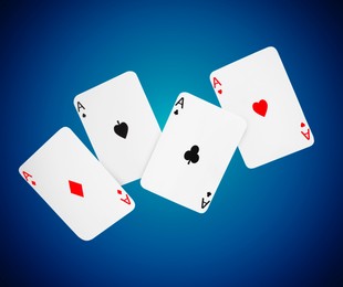 Image of Four aces in air on blue gradient background. Poker and other card games