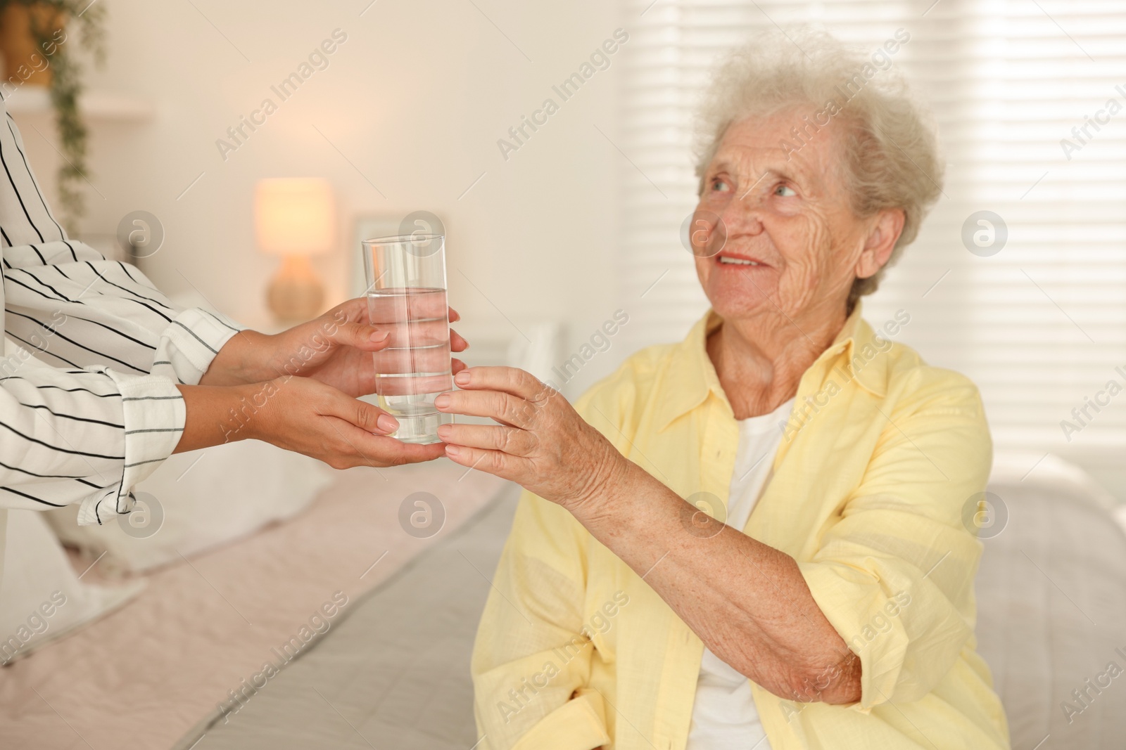 Photo of Senior woman getting glass of water indoors