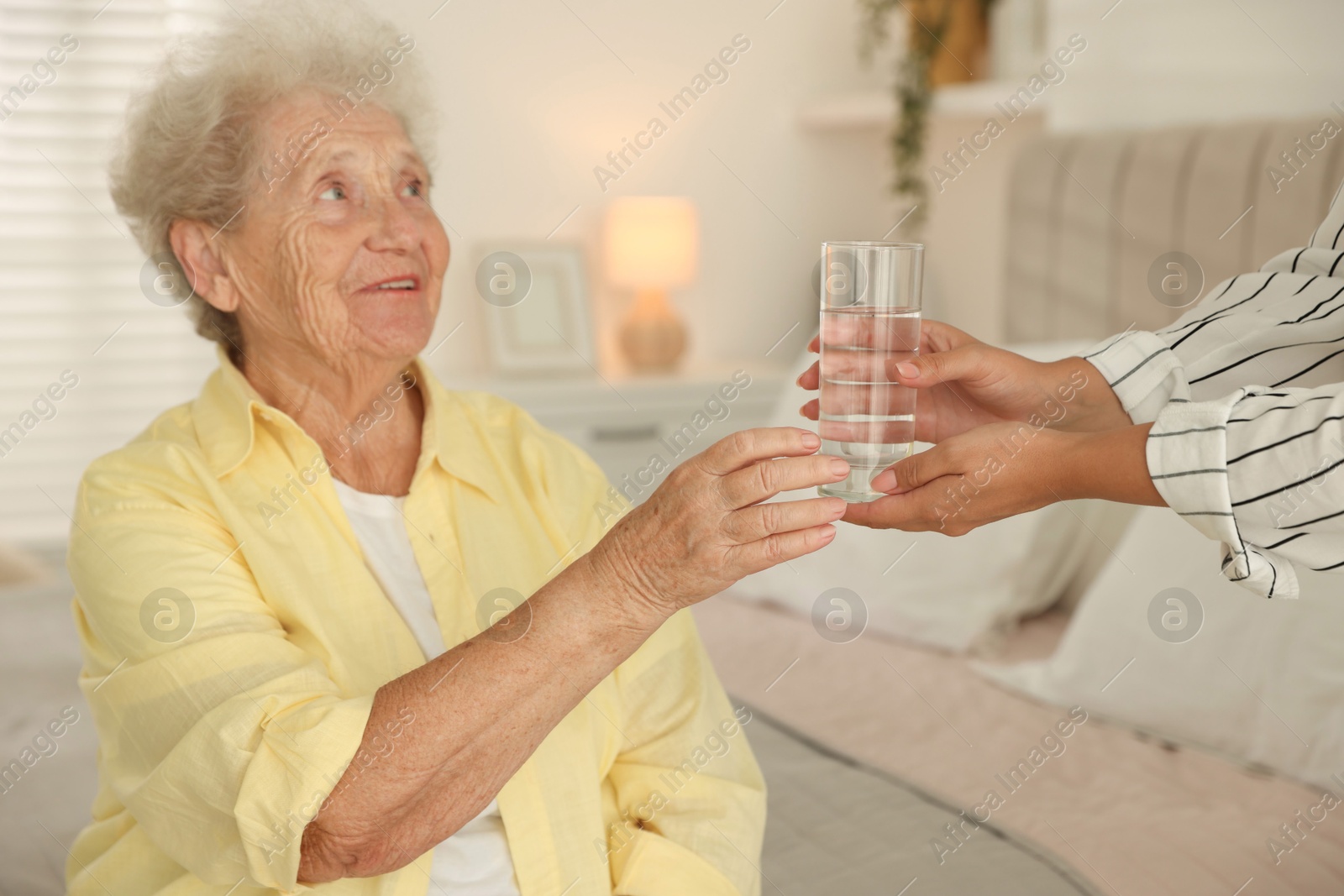 Photo of Senior woman getting glass of water indoors