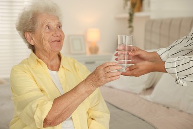 Photo of Senior woman getting glass of water indoors