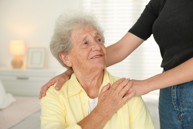 Senior woman with her granddaughter at home