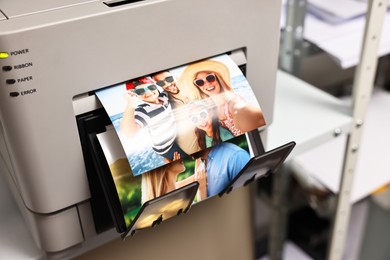 Photo of Modern printer with colorful photos indoors, closeup