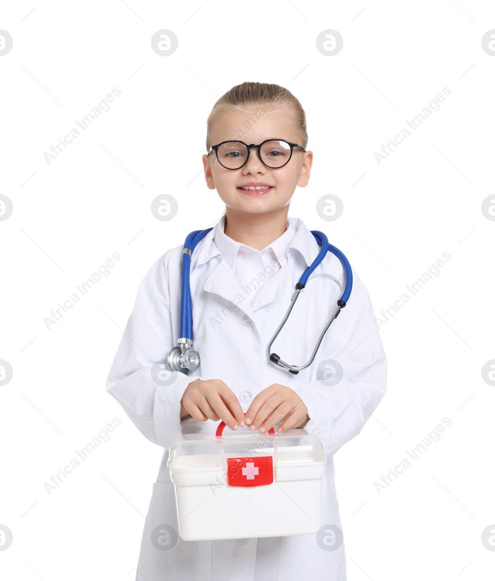 Photo of Little girl with stethoscope and first aid kit pretending to be doctor on white background. Dreaming of future profession