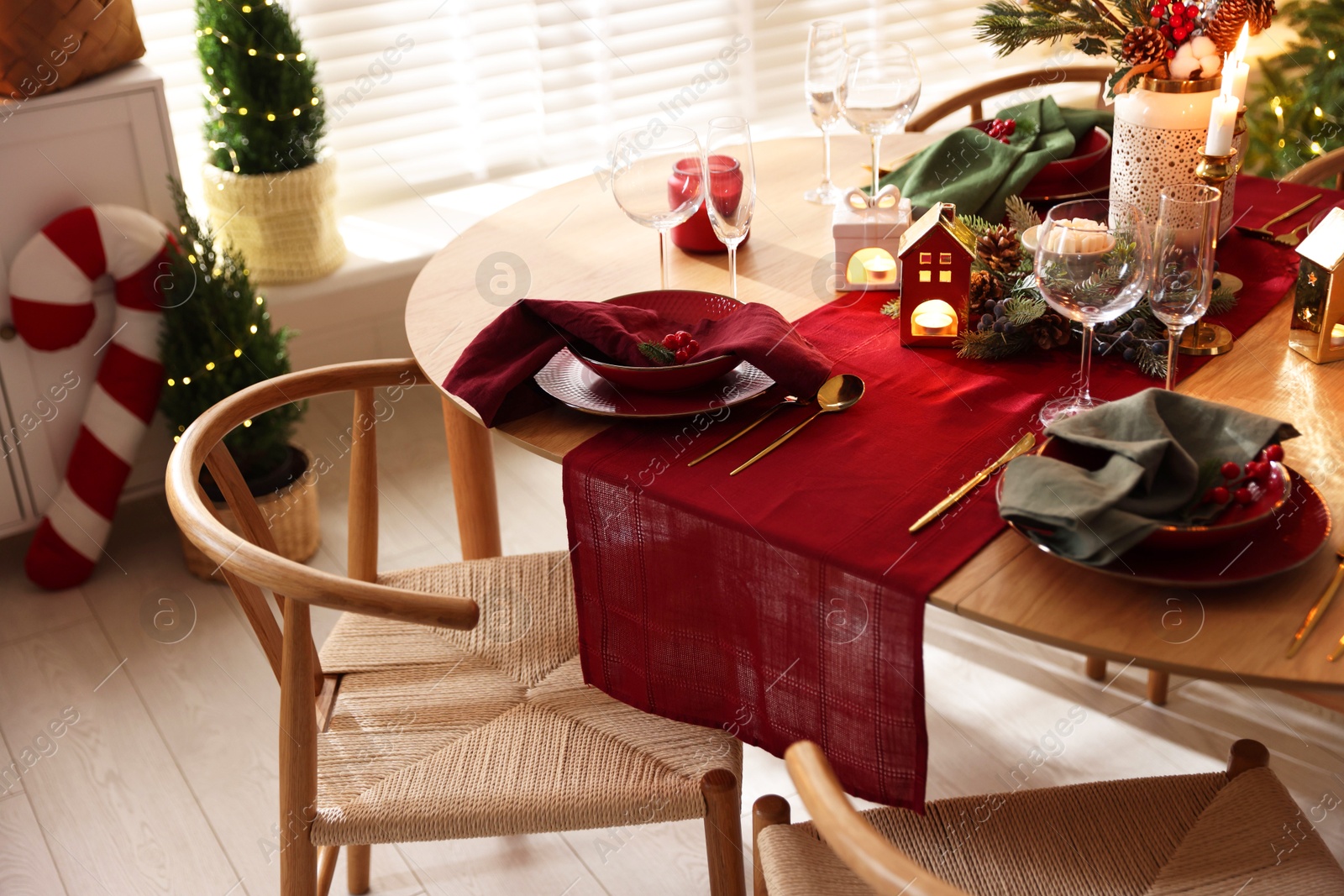 Photo of Christmas table setting with stylish dishware and festive decor indoors