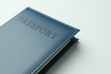 Photo of Passport in dark blue cover on light background, closeup. Space for text