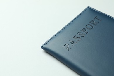 Photo of Passport in dark blue cover on light background, closeup. Space for text