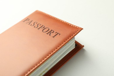 Photo of Passport in brown cover on light background, closeup