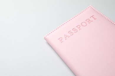 Photo of Passport in pink cover on light background, closeup. Space for text