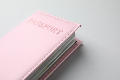 Photo of Passport in pink cover on light background, closeup. Space for text