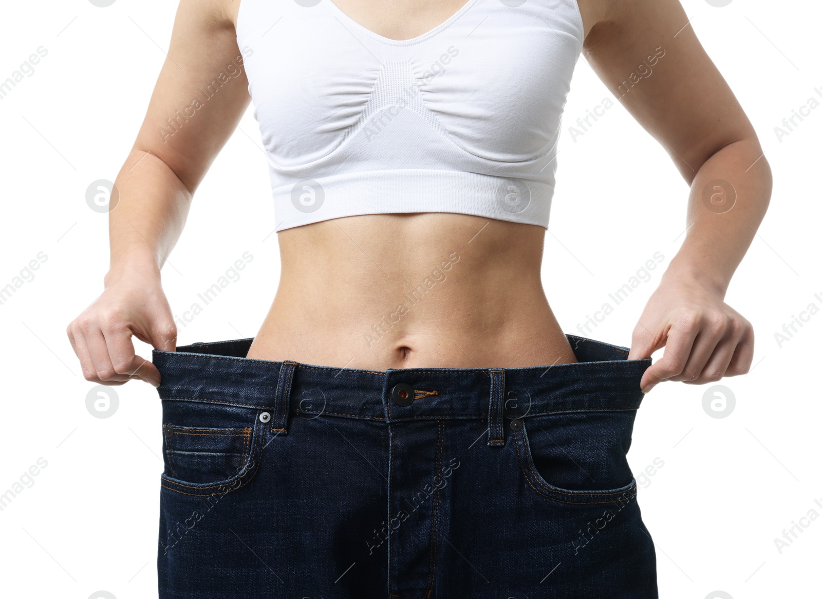 Photo of Weight loss. Woman wearing big jeans on white background, closeup