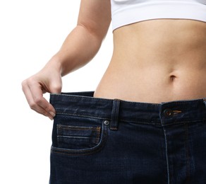 Photo of Weight loss. Woman wearing big jeans on white background, closeup