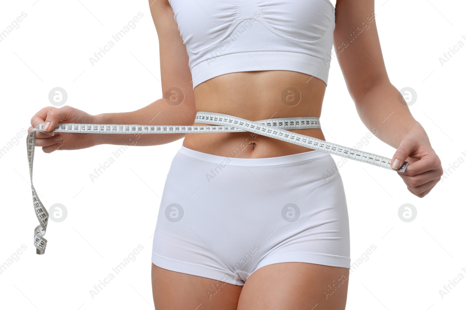 Photo of Weight loss. Woman measuring her slim waist with tape on white background, closeup