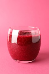 Photo of Fresh beetroot smoothie in glass on pink background, closeup