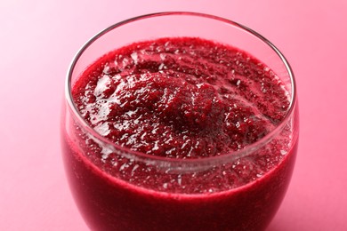 Photo of Fresh beetroot smoothie in glass on pink background, closeup