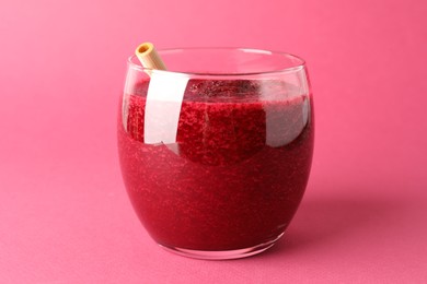 Photo of Fresh beetroot smoothie in glass on pink background, closeup