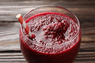 Photo of Fresh beetroot smoothie in glass on wooden table, closeup