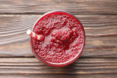 Photo of Fresh beetroot smoothie in glass on wooden table, top view