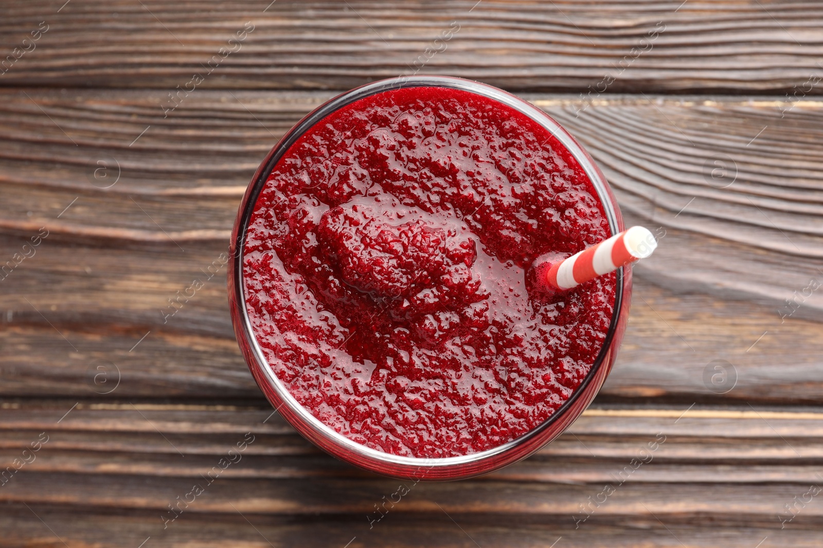 Photo of Fresh beetroot smoothie in glass on wooden table, top view