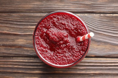 Photo of Fresh beetroot smoothie in glass on wooden table, top view