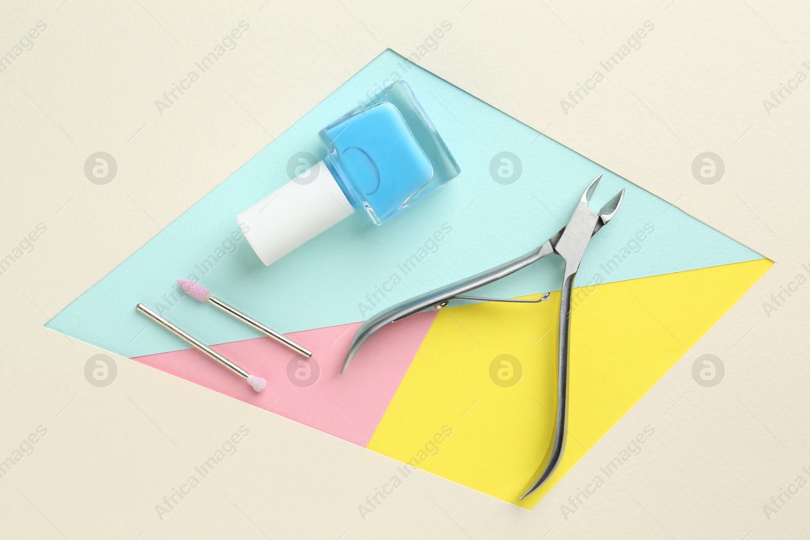 Photo of Set of pedicure tools on color background, flat lay