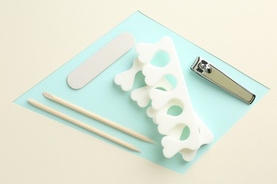 Photo of Set of pedicure tools on color background, flat lay