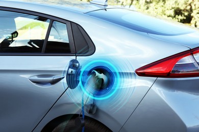 Image of Charging modern electric car from station outdoors. Round pulse waves representing energy