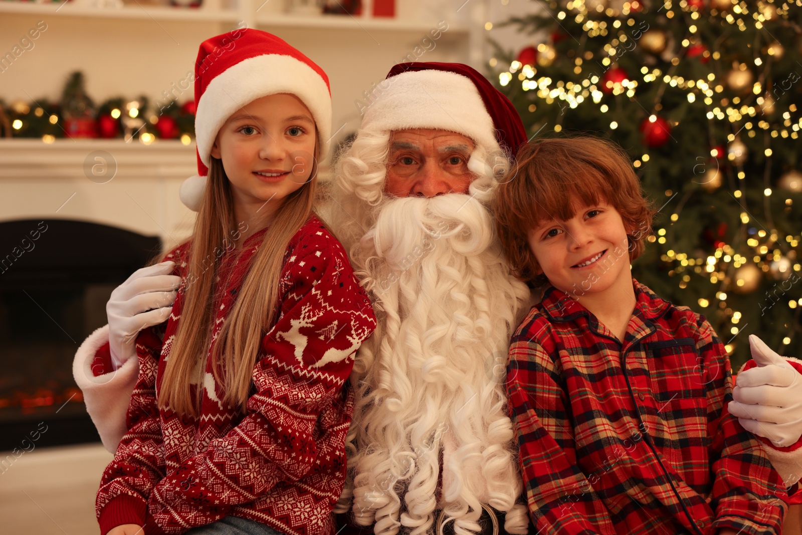 Photo of Christmas celebration. Santa Claus and kids at home