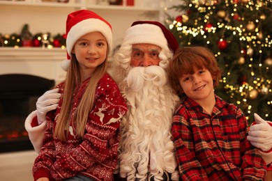 Christmas celebration. Santa Claus and kids at home