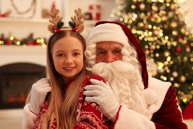 Christmas celebration. Santa Claus and girl at home