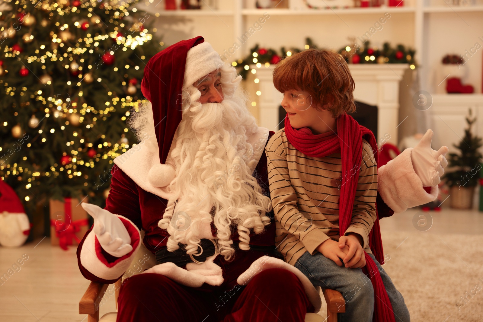 Photo of Christmas celebration. Santa Claus and boy at home