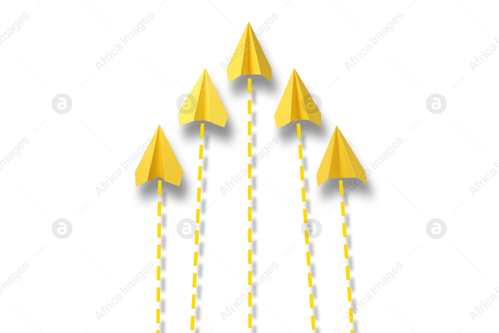 Image of Yellow paper planes with flight paths on white background. Dashed lines for trajectory