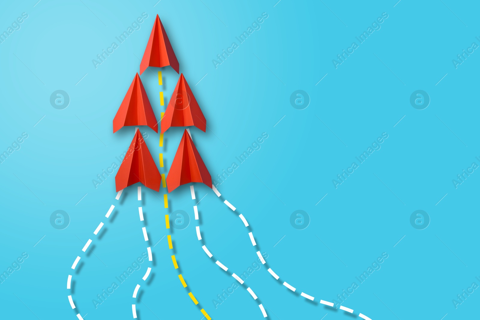 Image of Red paper planes with flight paths on light blue background. Dashed lines for trajectory