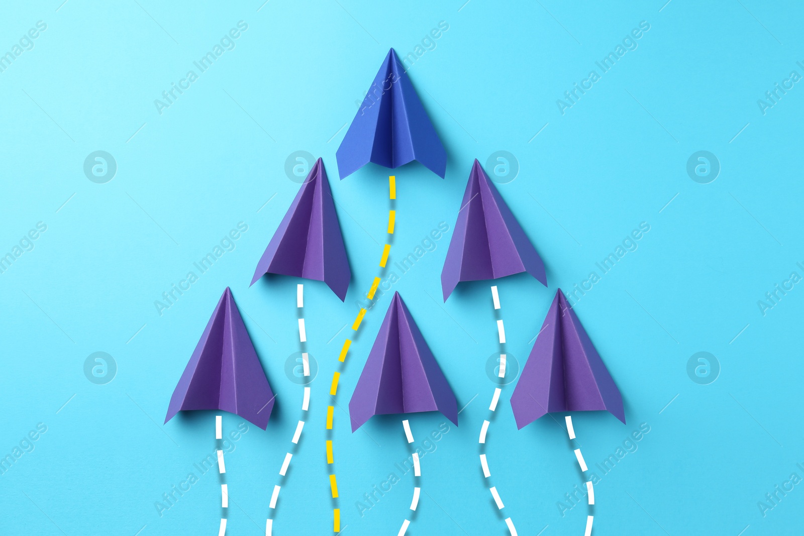 Image of Purple and one blue paper planes with flight paths on color background. Dashed lines for trajectory