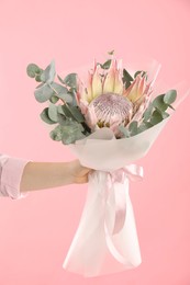 Photo of Woman with beautiful bouquet on pink background, closeup