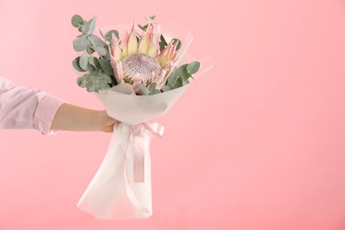 Photo of Woman with beautiful bouquet on pink background, closeup. Space for text