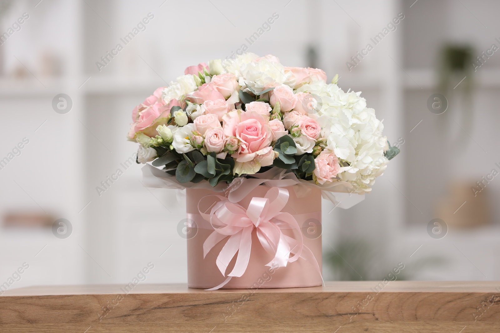 Photo of Beautiful bouquet in box on table at home