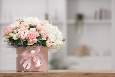 Photo of Beautiful bouquet in box on table at home. Space for text