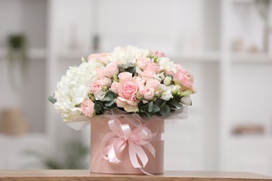 Photo of Beautiful bouquet in box on table at home