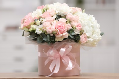 Photo of Beautiful bouquet in box on table at home