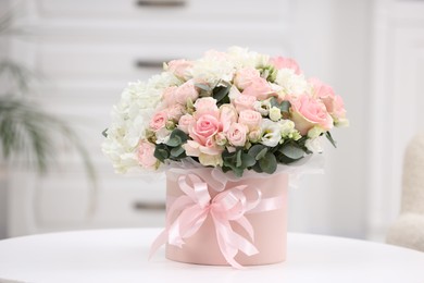 Photo of Beautiful bouquet in box on table at home