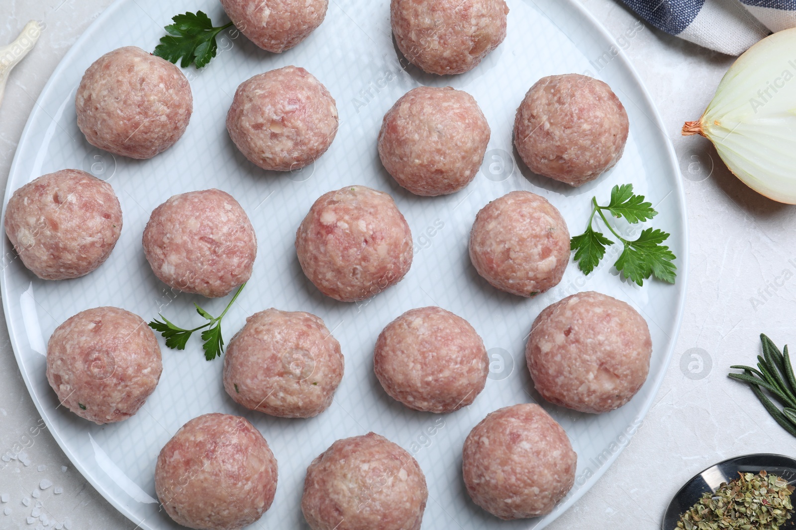 Photo of Many fresh raw meatballs on white table, flat lay