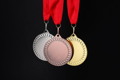 Photo of Golden, silver and bronze medals on black background