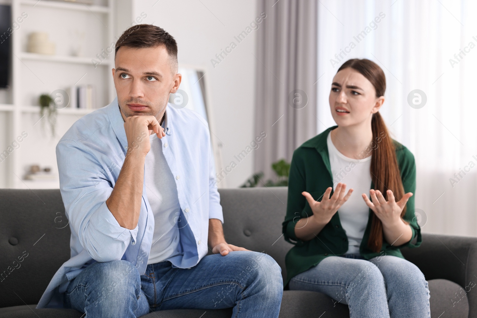 Photo of Husband ignoring his emotional wife at home