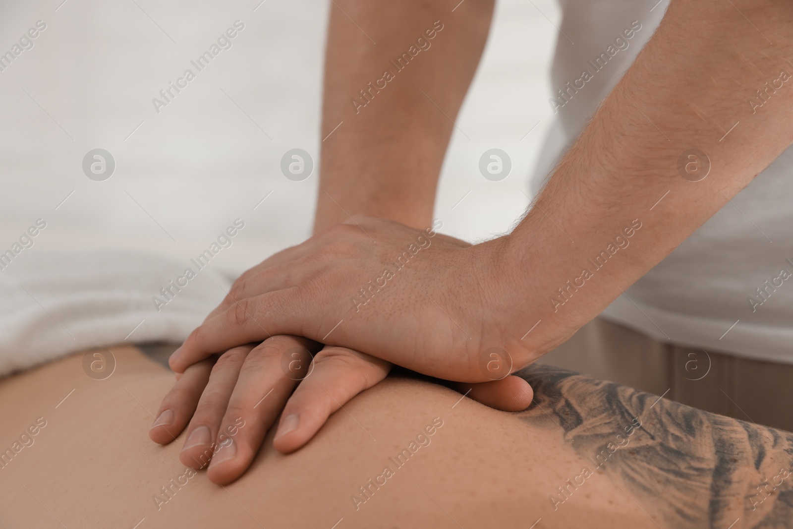 Photo of Massage therapist working with patient in clinic, closeup