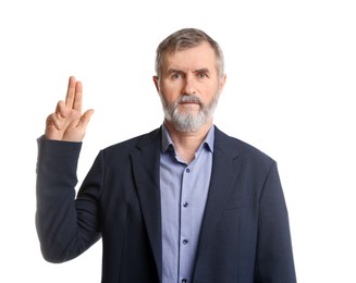 Photo of Mature man making promise on white background. Oath gesture