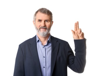 Photo of Mature man making promise on white background. Oath gesture