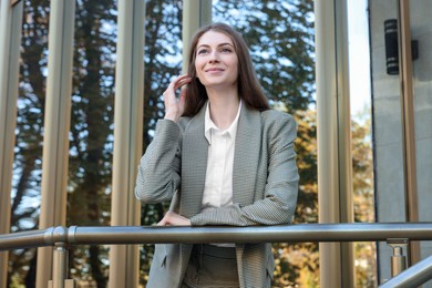 Portrait of young woman wearing stylish suit outdoors